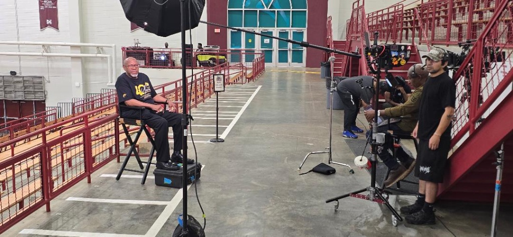 Professional film crew with camera rig filming inside Forbes Arena at Morehouse College