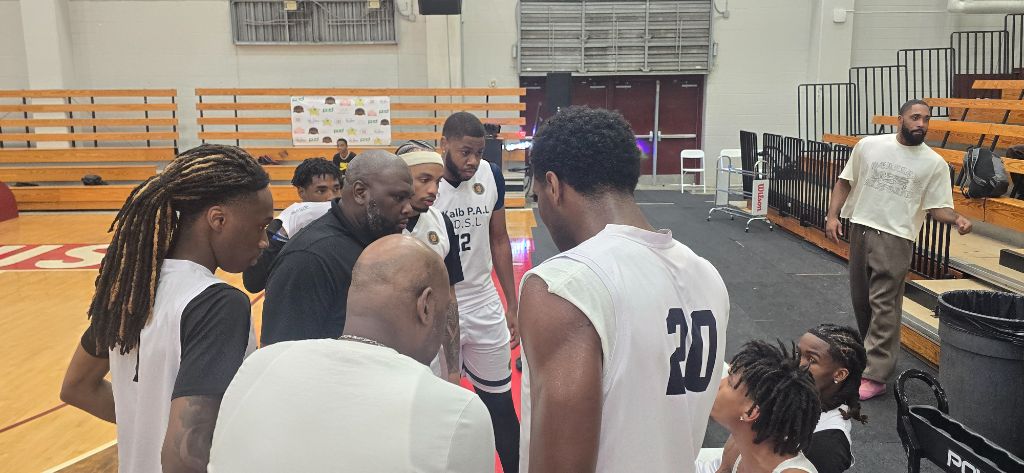 Team in white Kalb P.A.L. jerseys huddles tightly on the court before tipoff at Forbes Arena